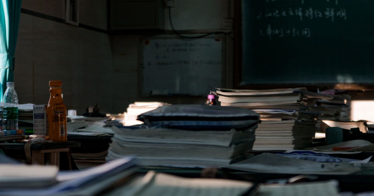 Stacks of paper documents on a desk — the kind of backlog a bulk email-to-PDF conversion clears.