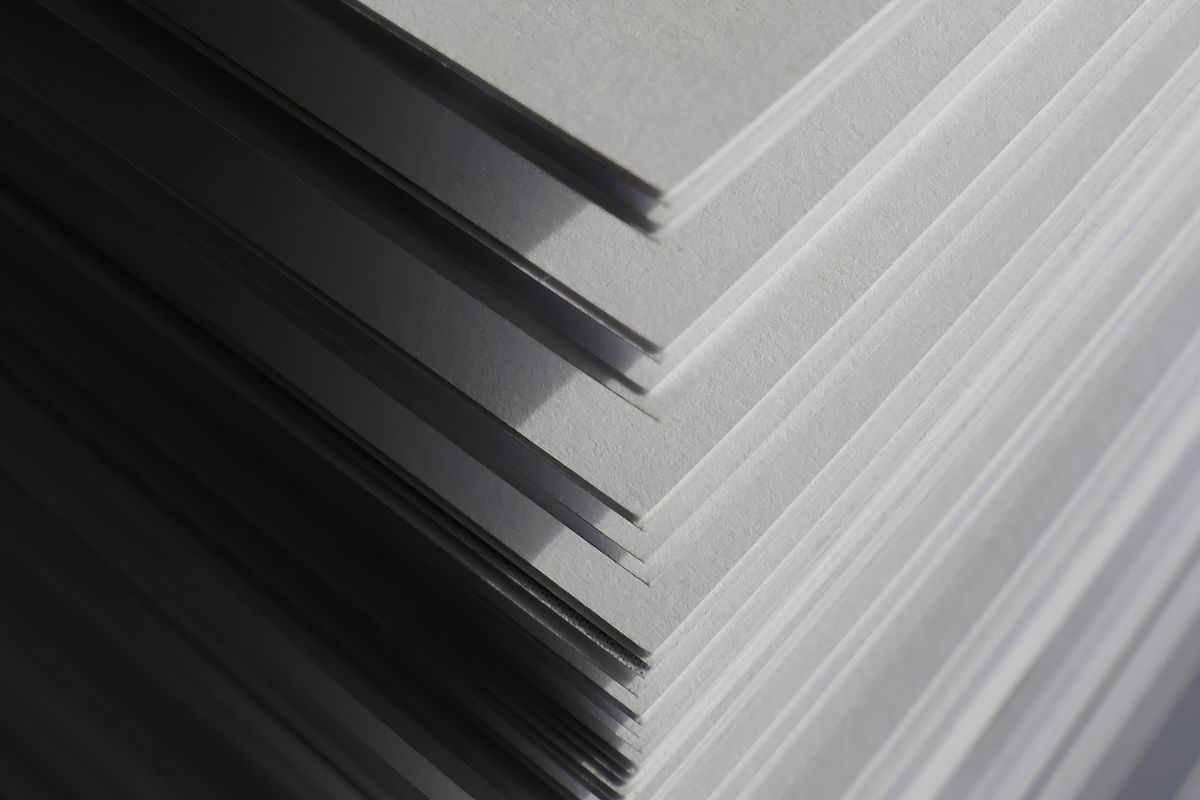Close-up of a stack of uncoated paper with a matte, slightly rough surface